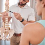 Chiropractor, spine and anatomy with a medical skeleton for advice and diagnosis of injury during p